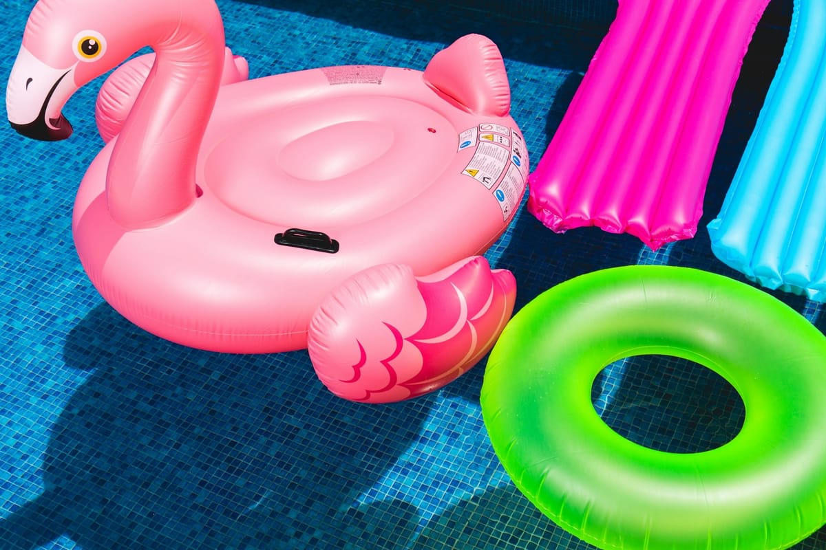 A photo of four colorful floats in a pool.